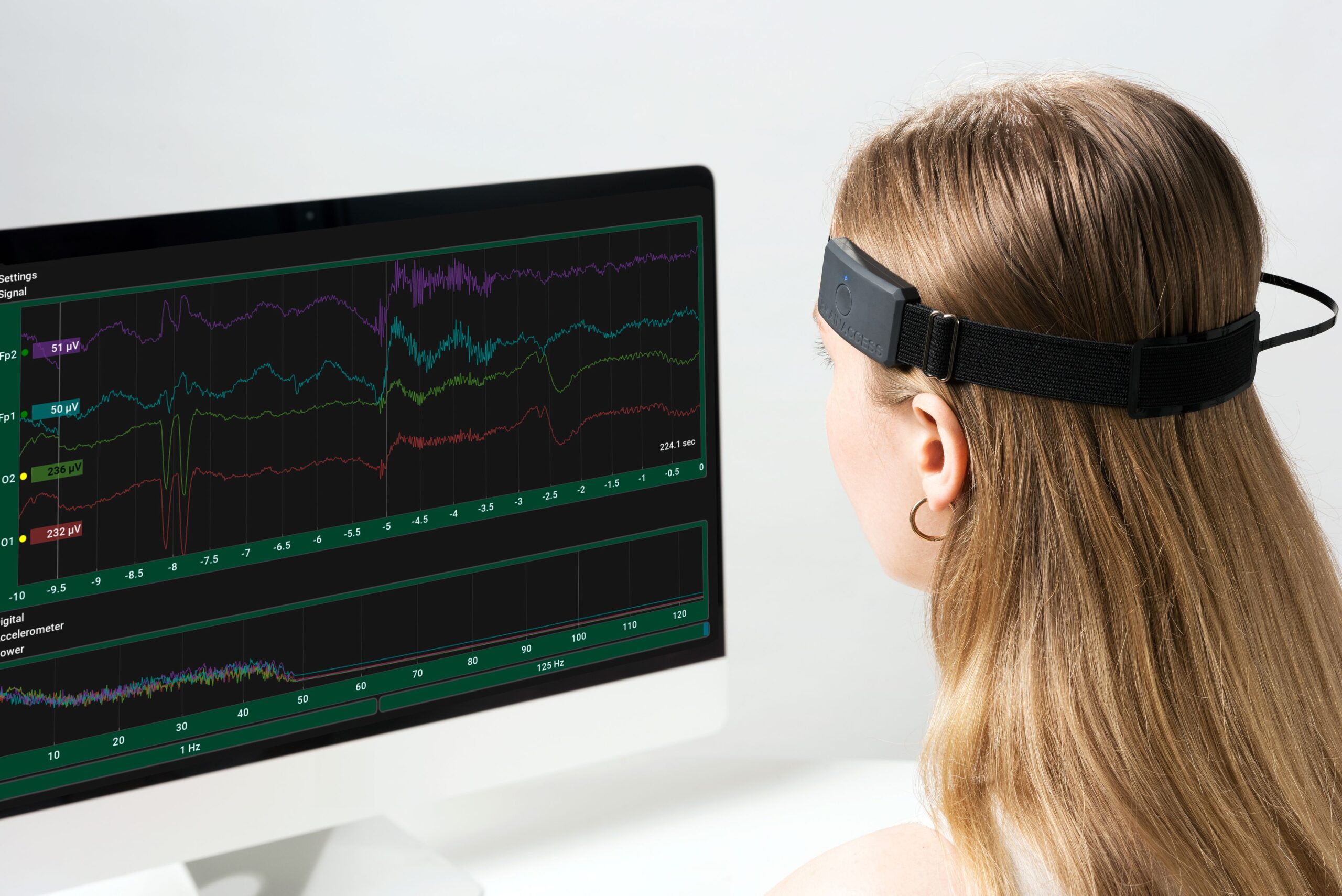 woman looking at computer screen brainwaves